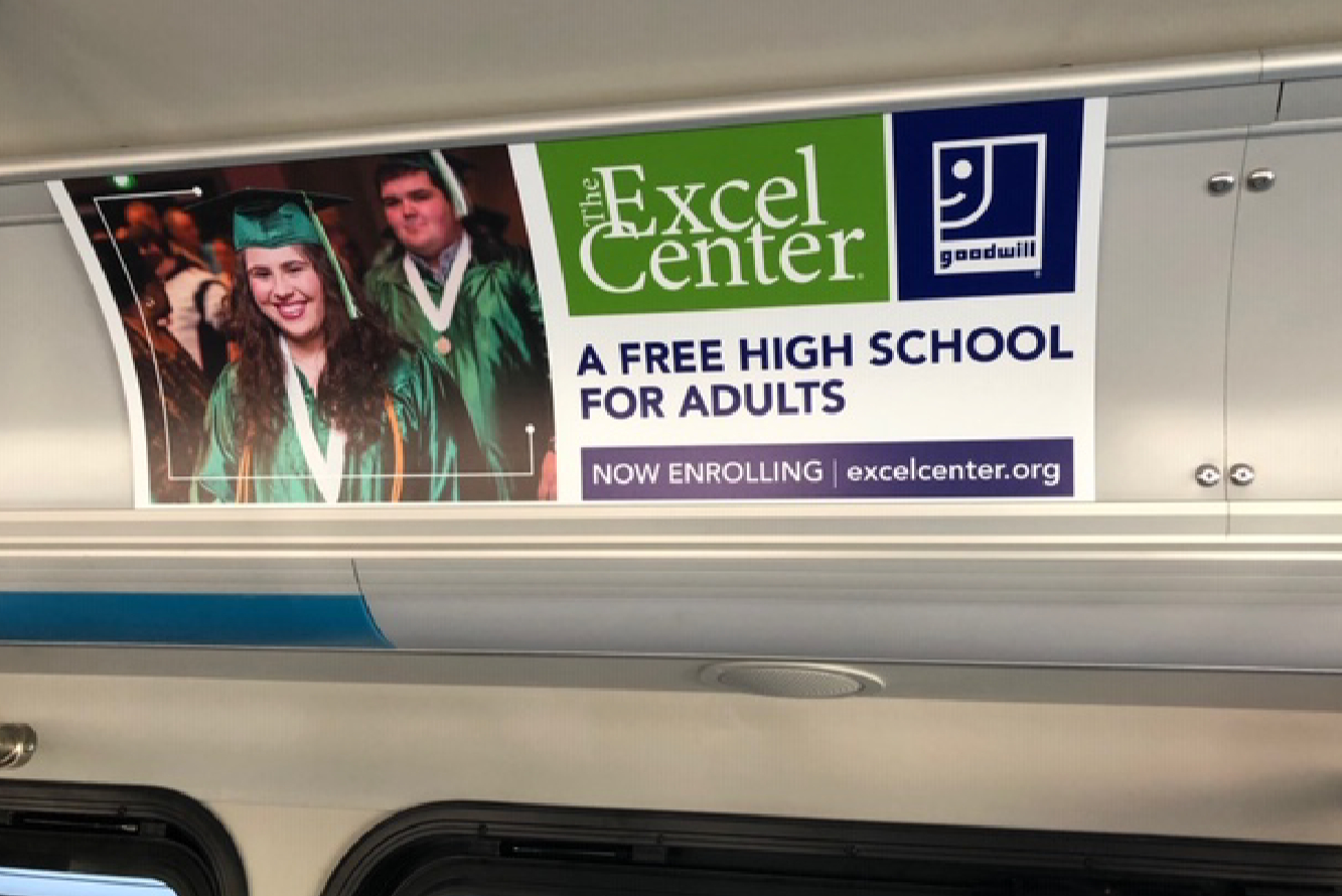 Educational institution advertisement on the side of a transit bus