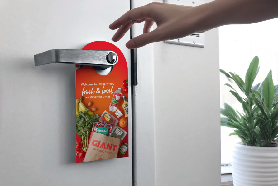 Hand placing branded door hanger advertisement on hotel room door