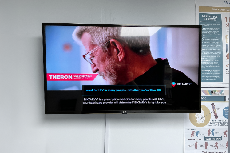 Educational institution advertisement on the side of a transit bus